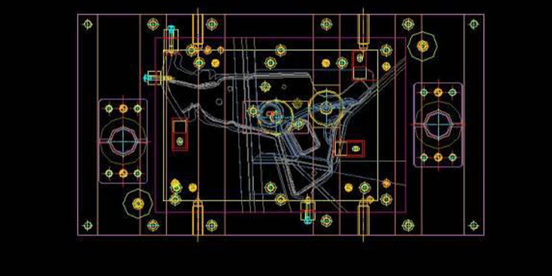 Engineer analyzing a mold part design with technical drawings and computer-aided design software