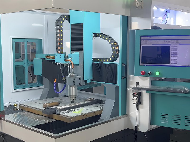 CNC engraving machine creating precision mold components with computer control